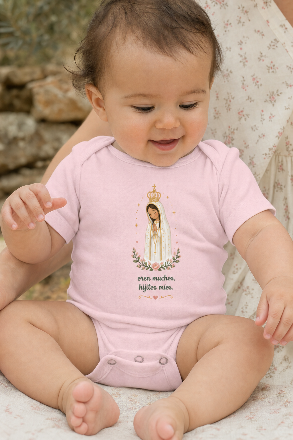 Baby girl wearing the Oren Muchos Fátima bodysuit in a lifestyle setting — detail