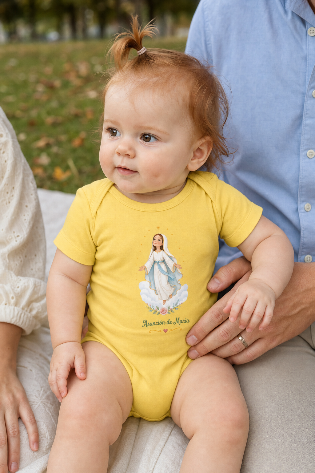 Baby girl wearing the Asunción de María Baby Bodysuit in Yellow