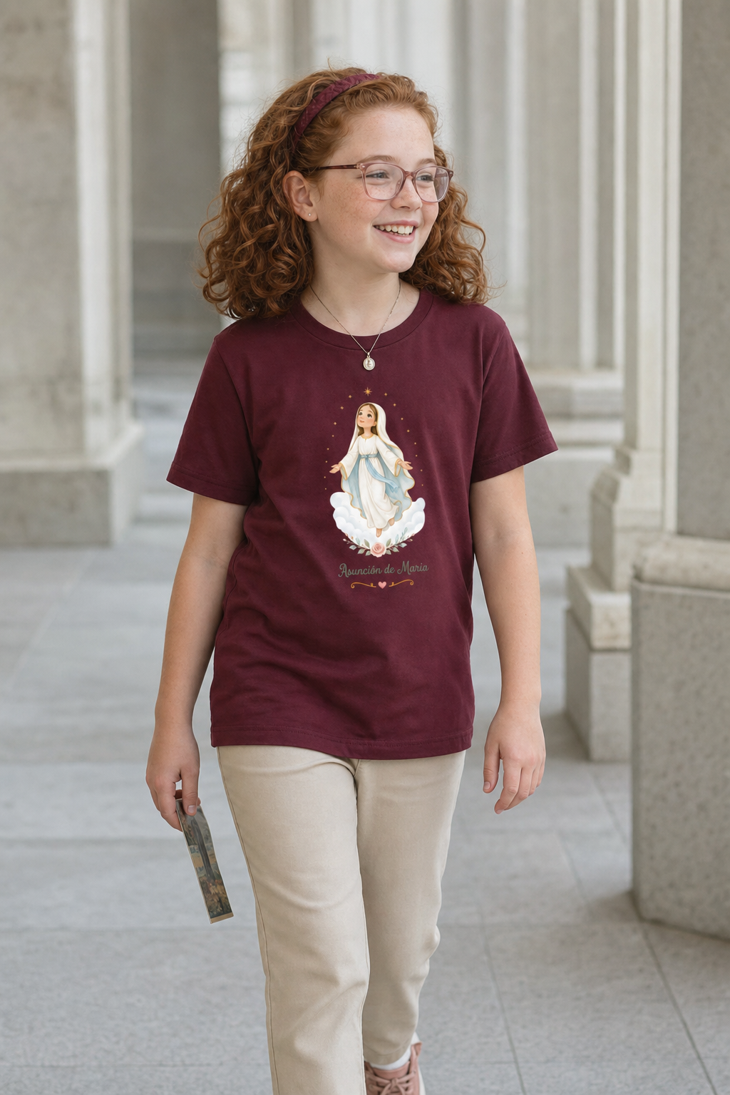 Girl wearing the Asunción de María Girls T-Shirt in Maroon