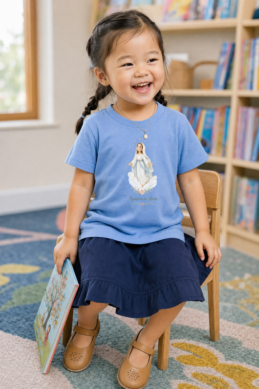 Little girl wearing the Asunción de María Toddler T-Shirt in Heather Columbia Blue