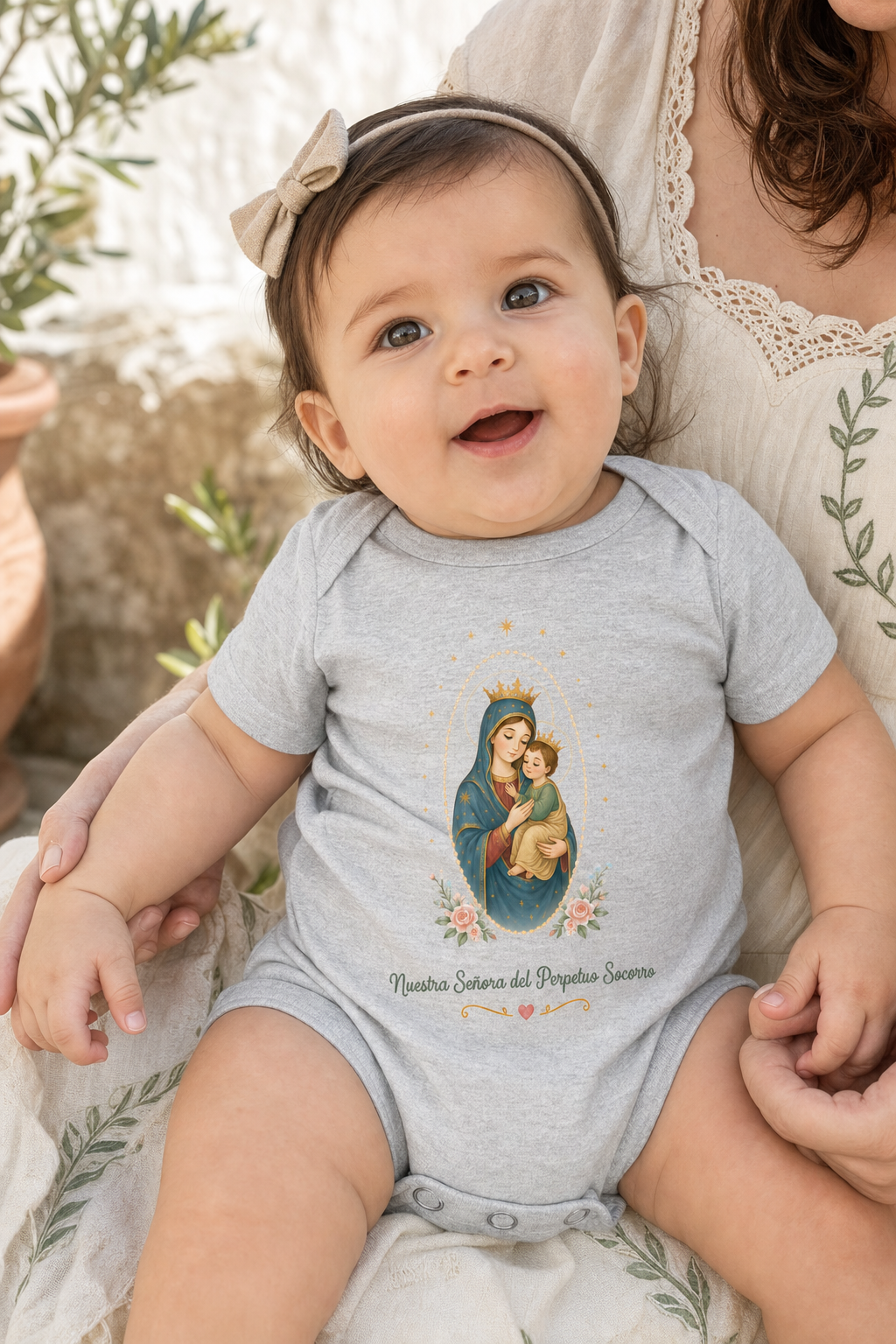 Baby girl wearing the Nuestra Señora del Perpetuo Socorro bodysuit in a lifestyle setting — detail