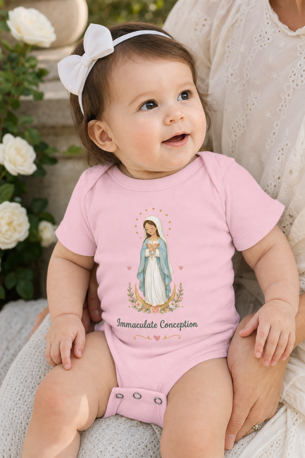 Baby girl wearing the Immaculate Conception bodysuit in a lifestyle setting — detail