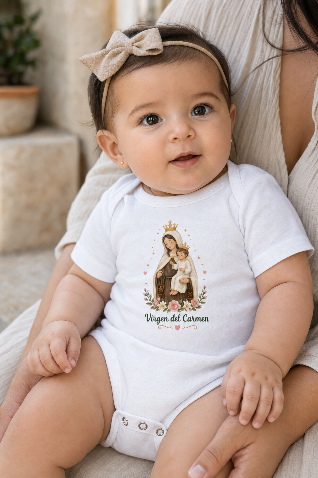 Baby girl wearing the Virgen del Carmen bodysuit in a lifestyle setting — detail
