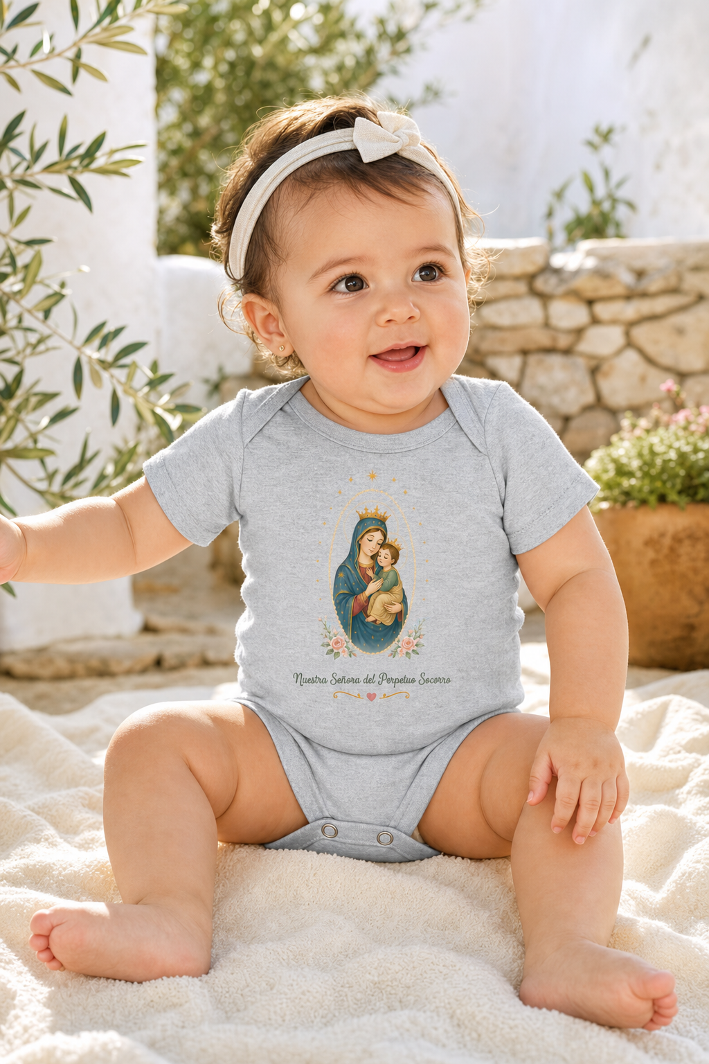 Baby girl wearing the Nuestra Señora del Perpetuo Socorro bodysuit in a lifestyle setting