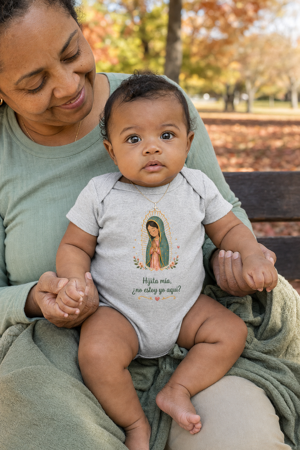 Baby girl wearing the Hijita Mía Guadalupe Baby Bodysuit in Athletic Heather