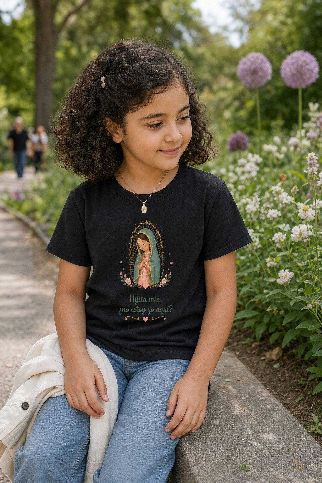 Girl wearing the Hijita Mía Guadalupe Girls T-Shirt in Black