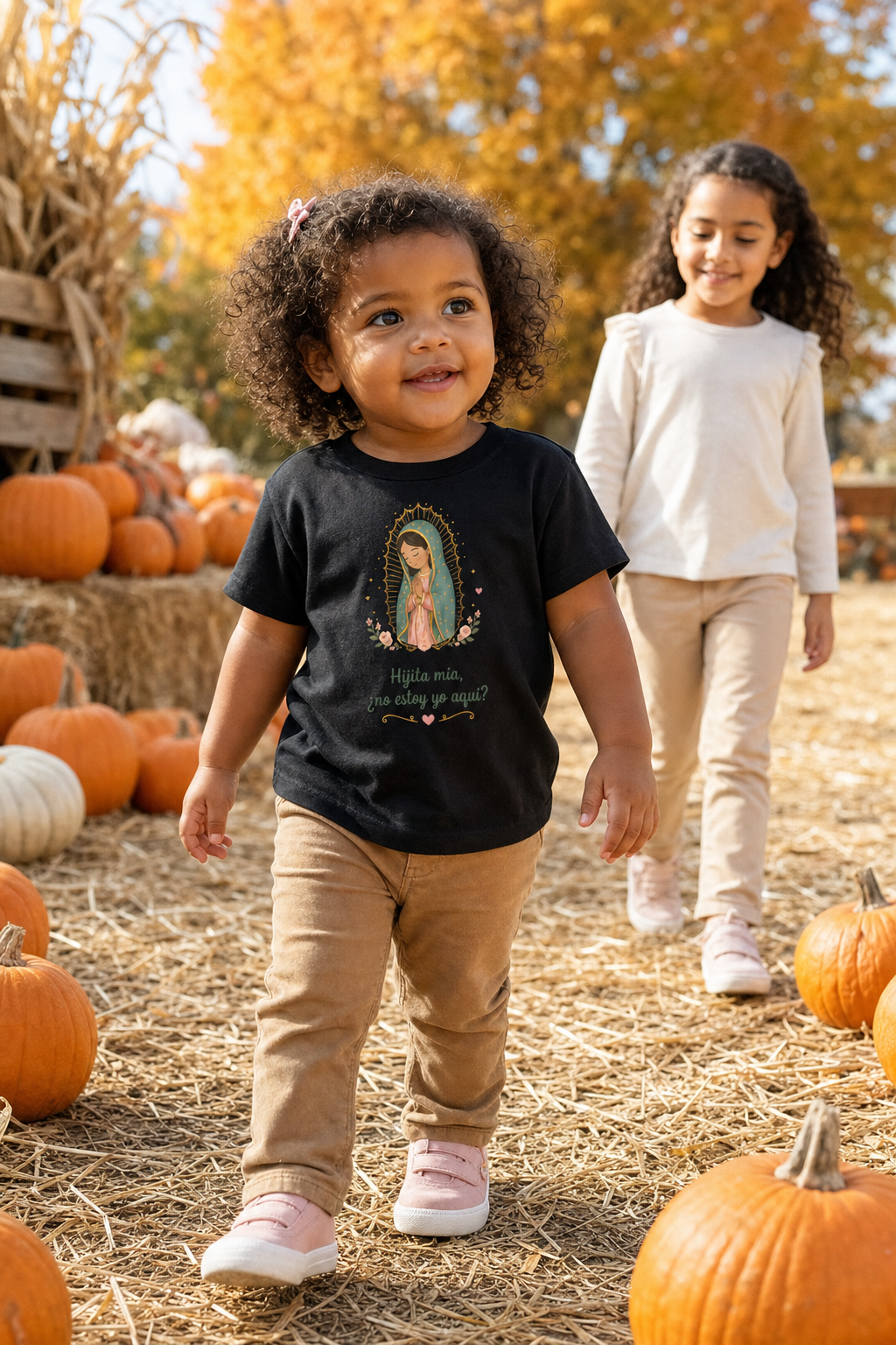 Little girl wearing the Hijita Mía Guadalupe Toddler T-Shirt in Black