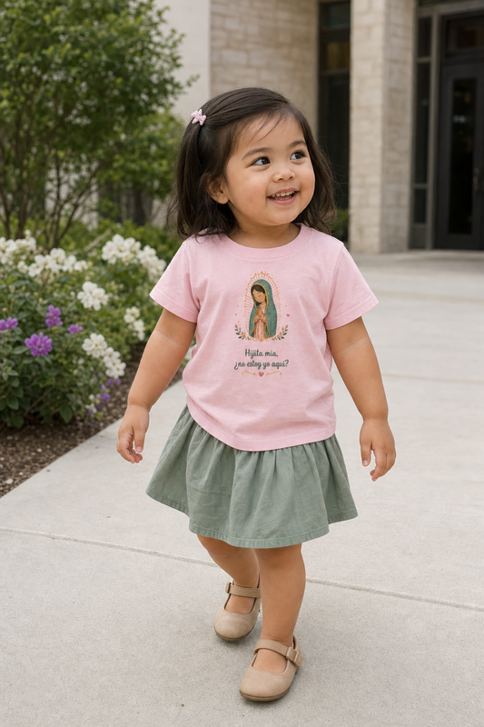 Little girl wearing the Hijita Mía Guadalupe Toddler T-Shirt in Pink