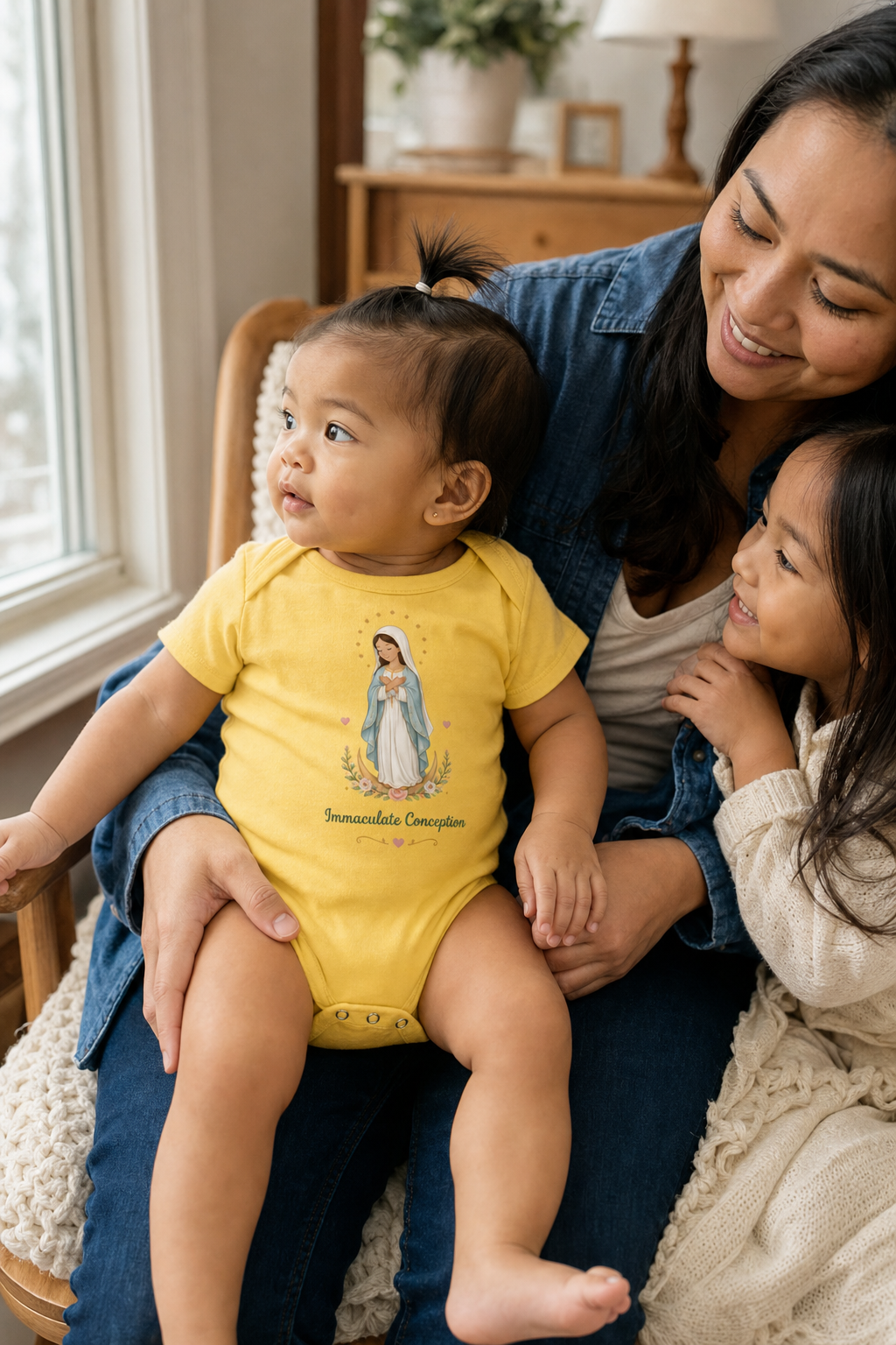 Baby girl wearing the Immaculate Conception Baby Bodysuit in Yellow