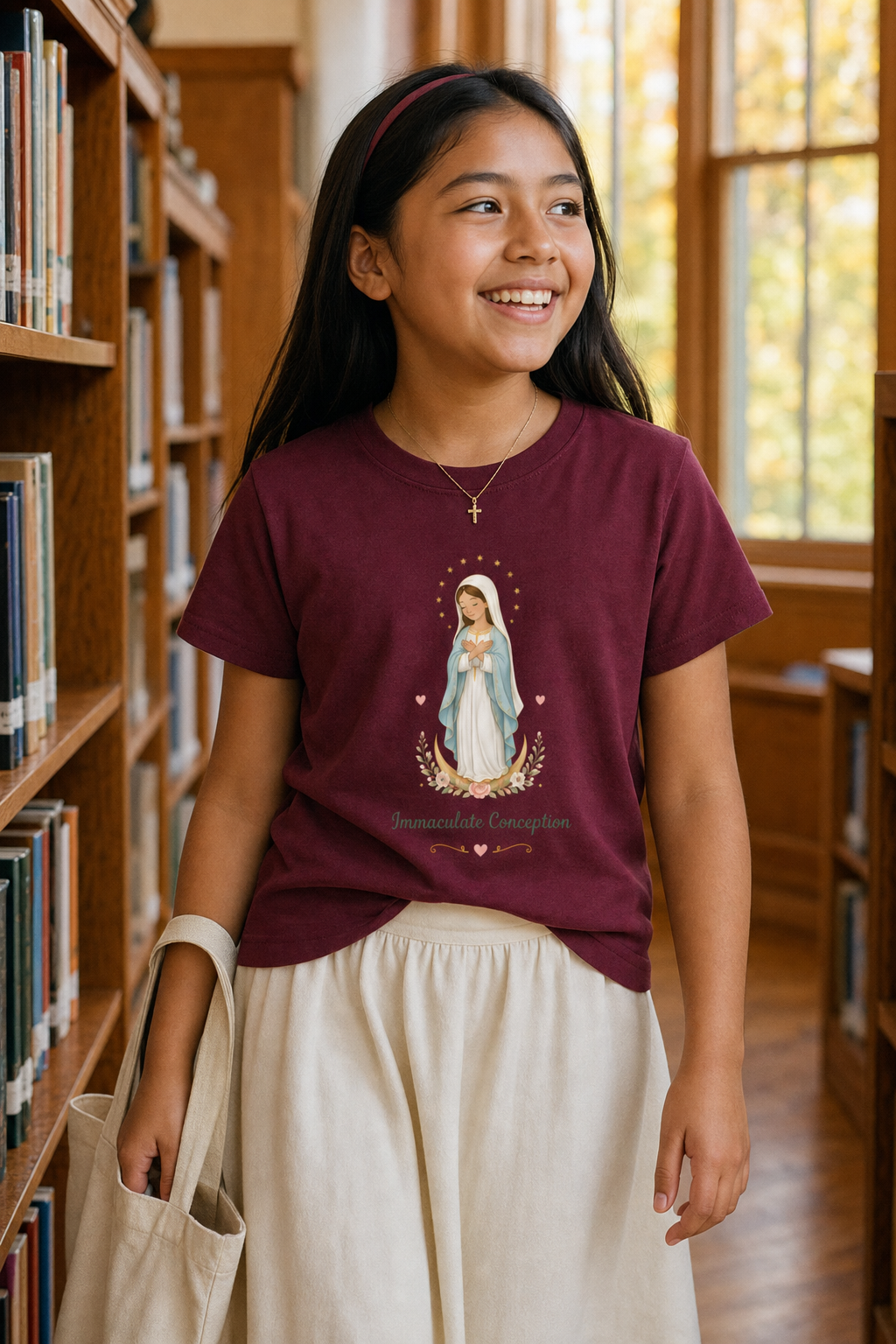 Girl wearing the Immaculate Conception Girls T-Shirt in Maroon