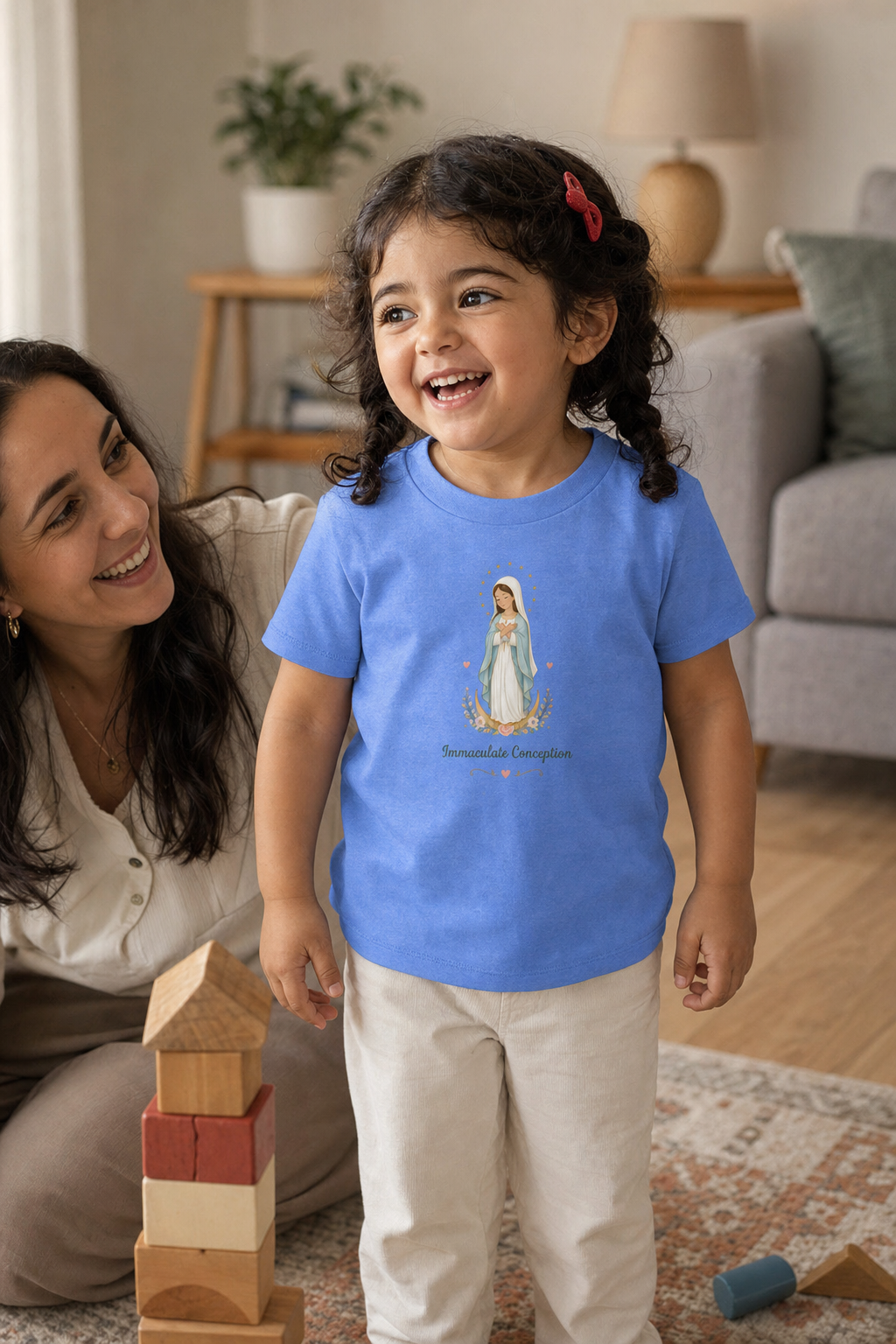 Little girl wearing the Immaculate Conception Toddler T-Shirt in Heather Columbia Blue