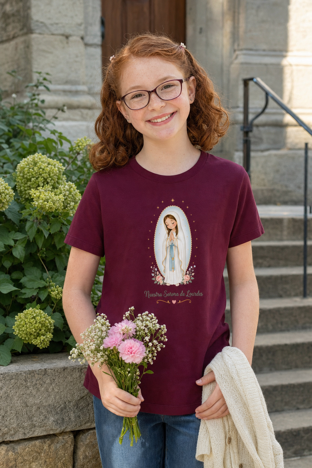 Girl wearing the Nuestra Señora de Lourdes Girls T-Shirt in Maroon