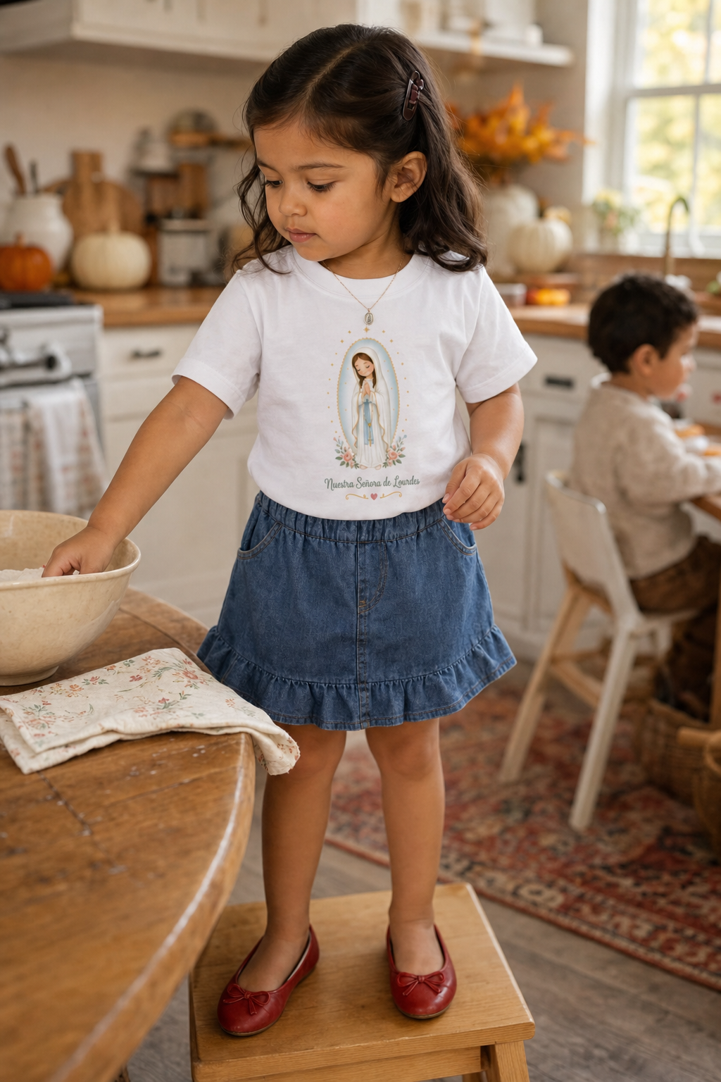 Little girl wearing the Nuestra Señora de Lourdes Toddler T-Shirt in White