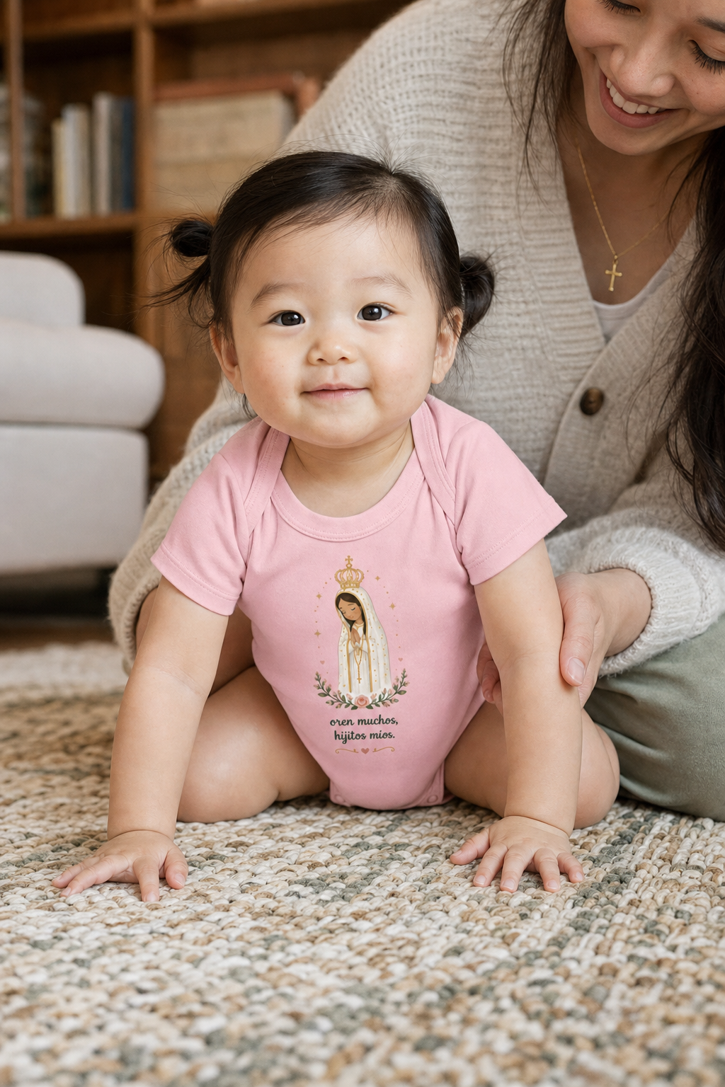 Baby girl wearing the Oren Muchos Fátima Baby Bodysuit in Pink