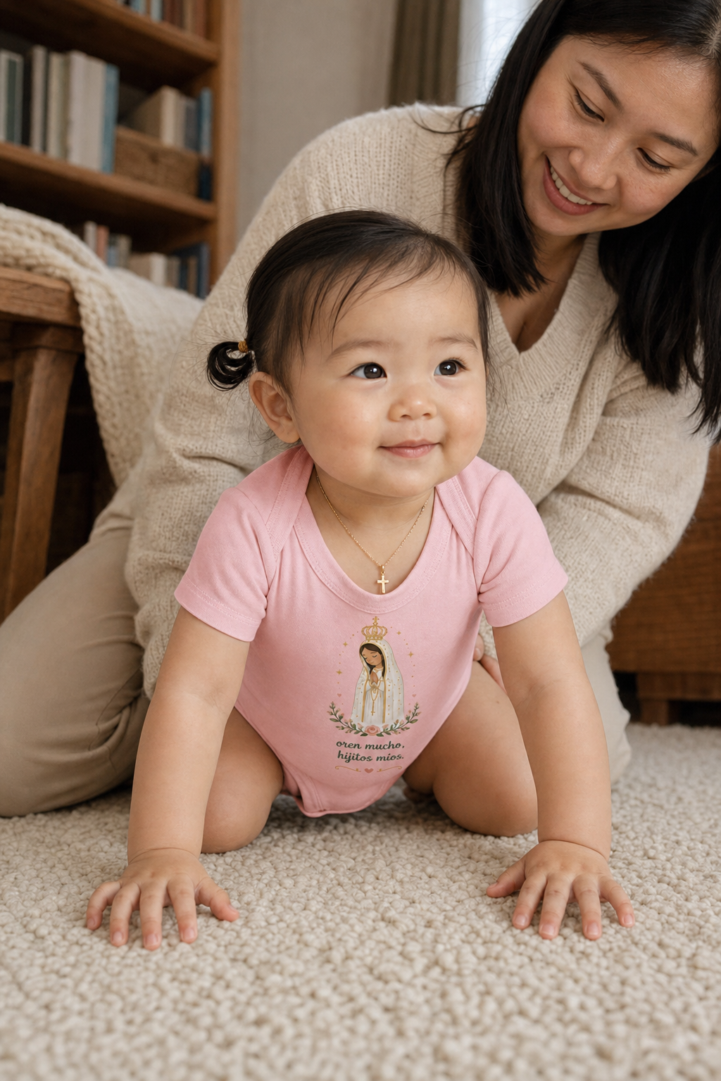 Baby girl wearing the Oren Mucho Fátima Baby Bodysuit in Pink