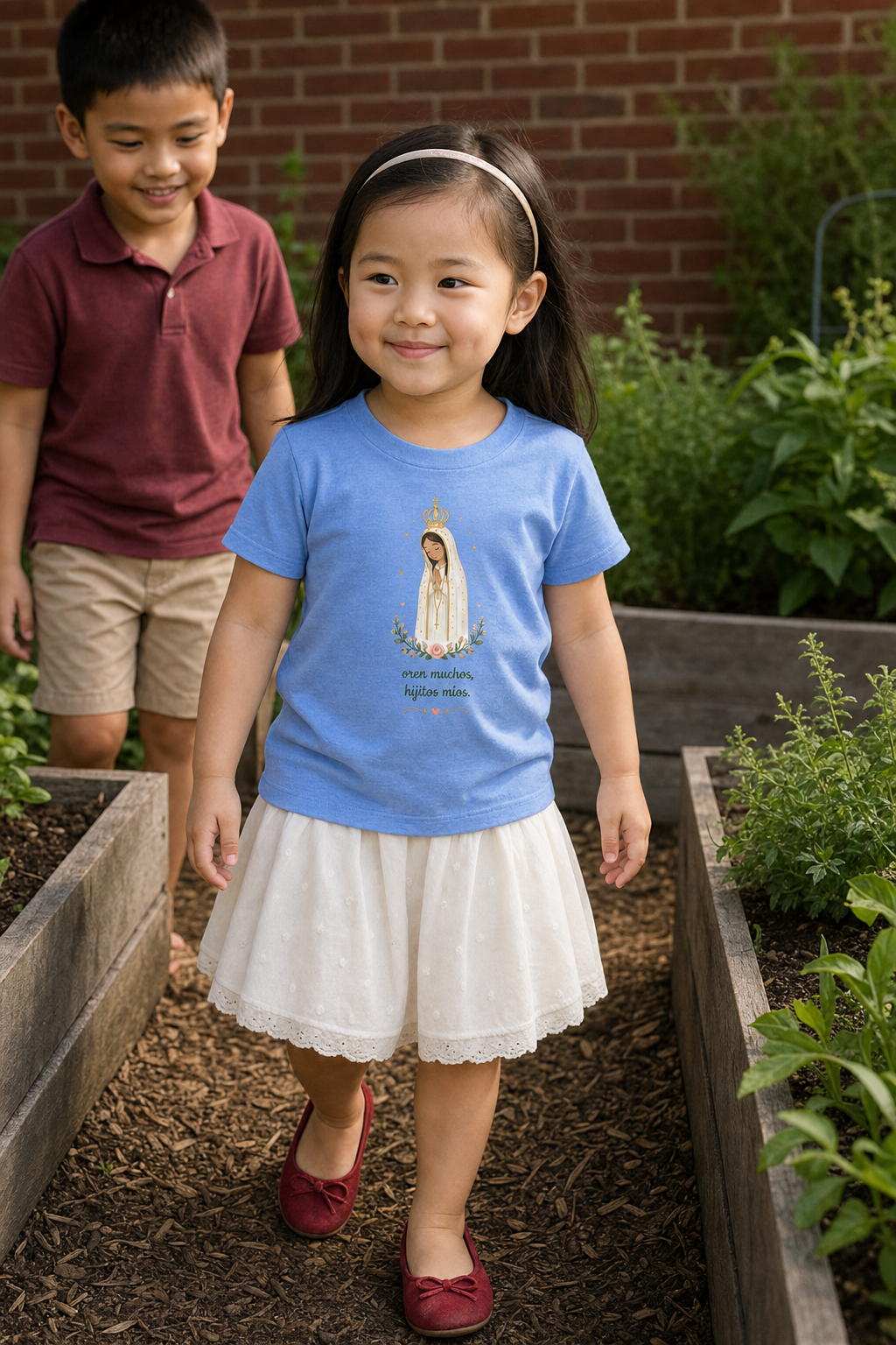 Little girl wearing the Oren Muchos Fátima Toddler T-Shirt in Heather Columbia Blue