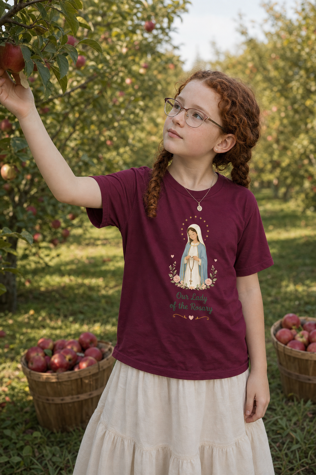 Girl wearing the Our Lady of the Rosary Girls T-Shirt in Maroon