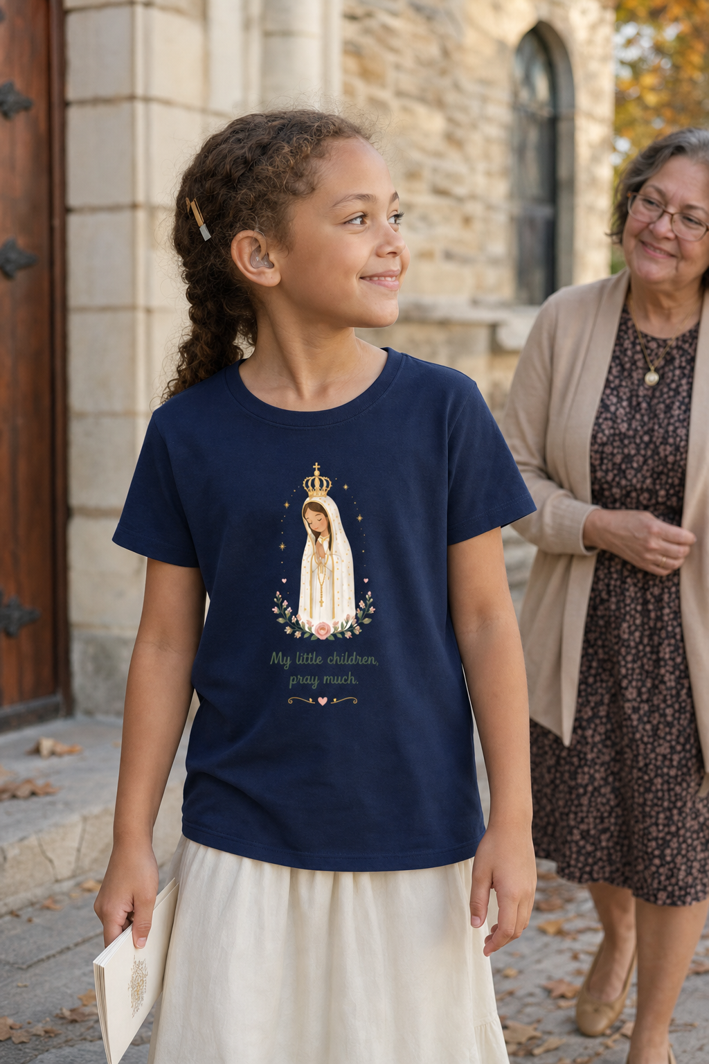 Girl wearing the Pray Much Fátima Girls T-Shirt in Navy