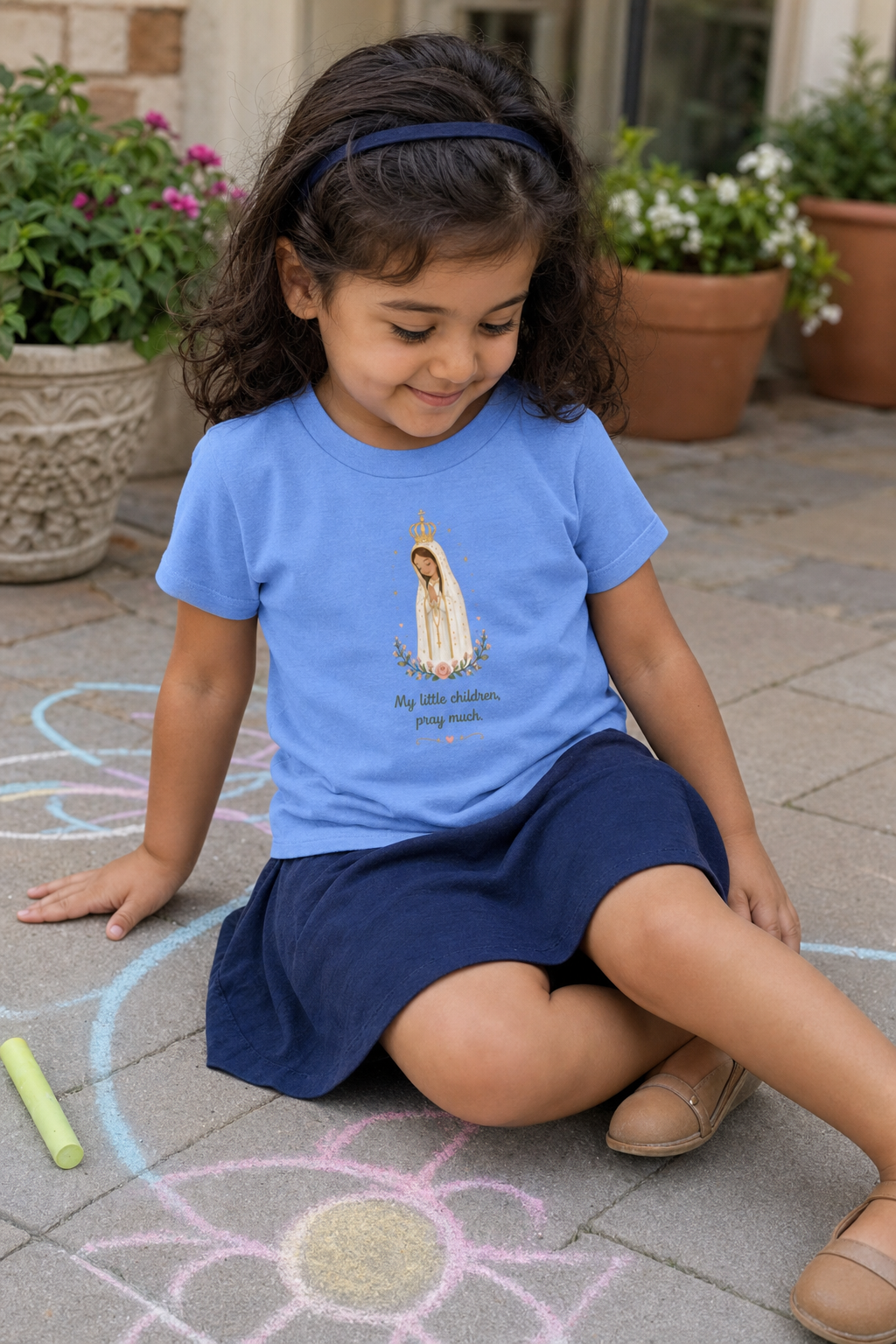 Little girl wearing the Pray Much Fátima Toddler T-Shirt in Heather Columbia Blue