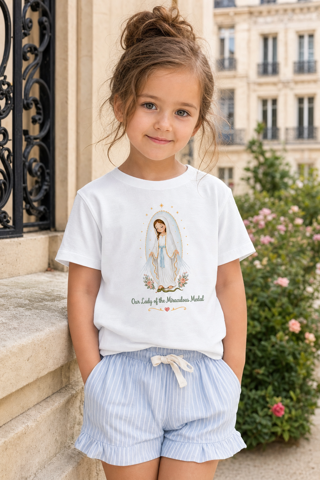 Little girl wearing the Our Lady of the Miraculous Medal toddler T-shirt in a lifestyle setting