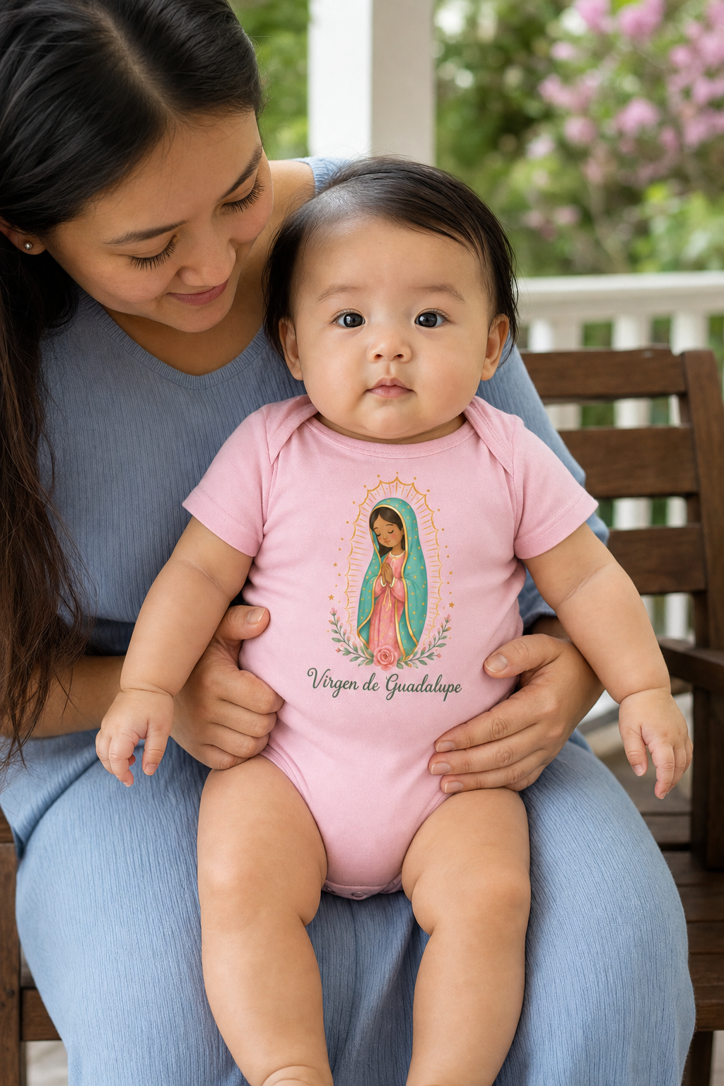 Baby girl wearing the Virgen de Guadalupe Baby Bodysuit in Pink