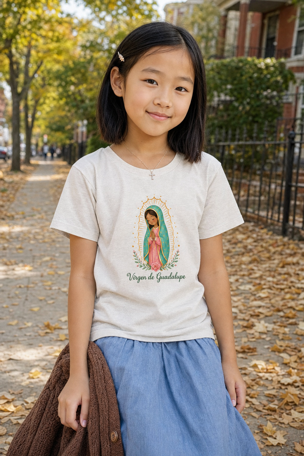 Girl wearing the Virgen de Guadalupe Girls T-Shirt in Heather Dust
