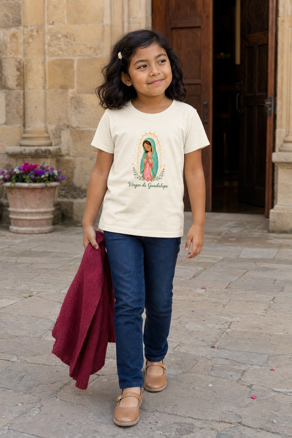 Girl wearing the Virgen de Guadalupe Girls T-Shirt in Natural