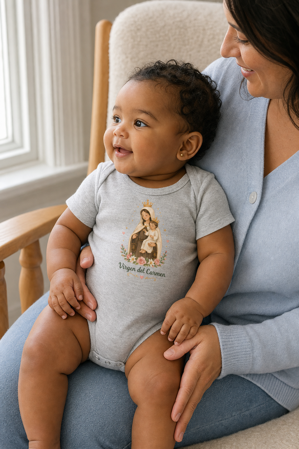 Baby girl wearing the Virgen del Carmen Baby Bodysuit in Athletic Heather