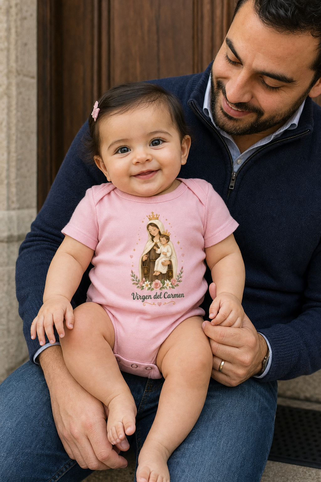 Baby girl wearing the Virgen del Carmen Baby Bodysuit in Pink