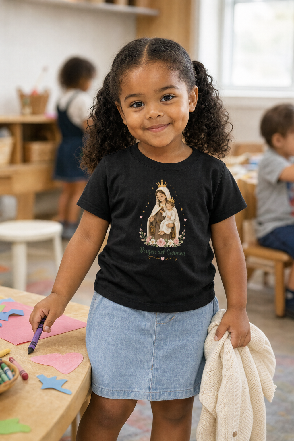 Little girl wearing the Virgen del Carmen Toddler T-Shirt in Black